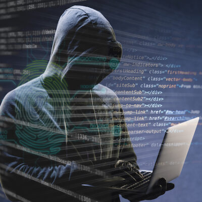 Hacker using a computer to write code.