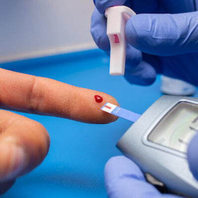 Closeup shot of a doctor with rubber gloves taking a blood test from a patient