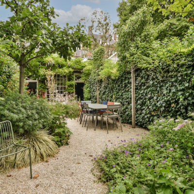 Simple small patio with small garden near wooden fence