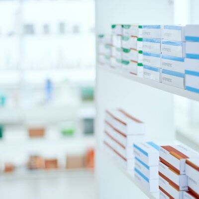 Medicine boxes on a pharmacy shelf.