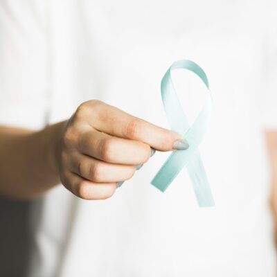 Woman holding a ribbon.