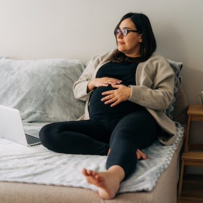 Pregnant woman lying on her bed.